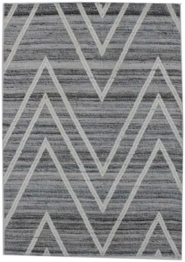 A grey and white rug with zigzag pattern  Description automatically generated