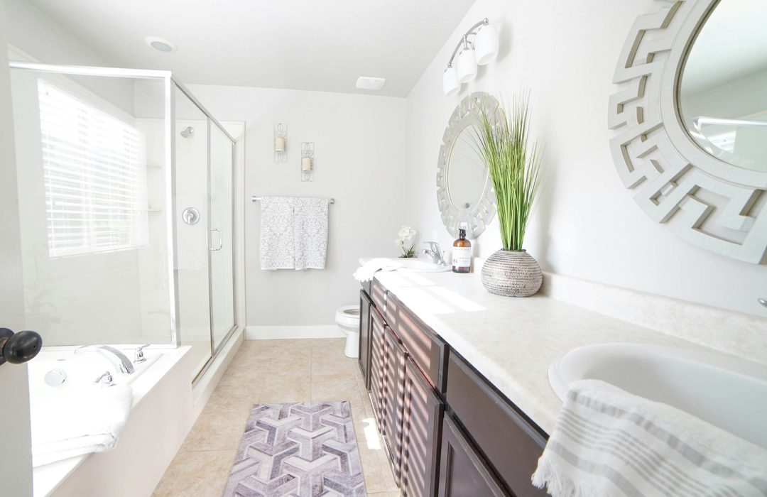 A bathroom with a rug in front of the vanity