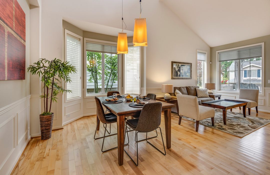 A dining room with the table and chairs on a rug
